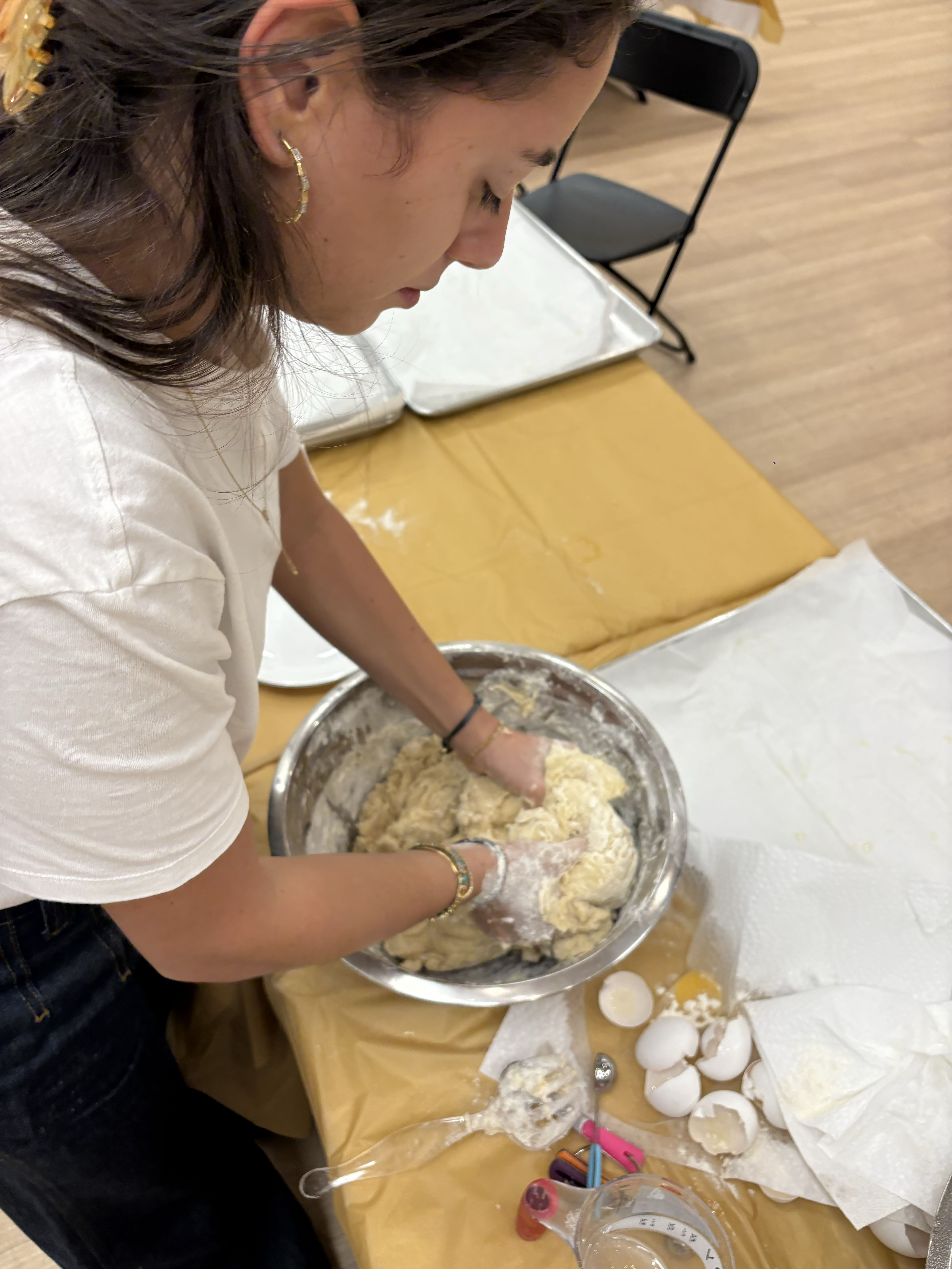 Photo shows Esther Esses making chalah for her weekly shabbat dinners