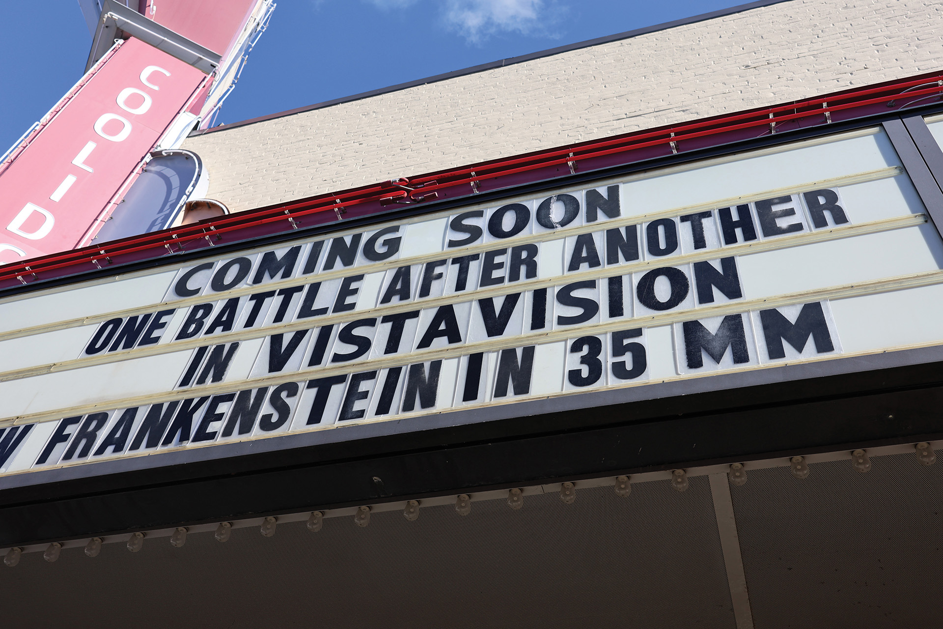 Photo of the side marquee at the Coolidge that says Coming Soon One Battle After Another In VistaVision