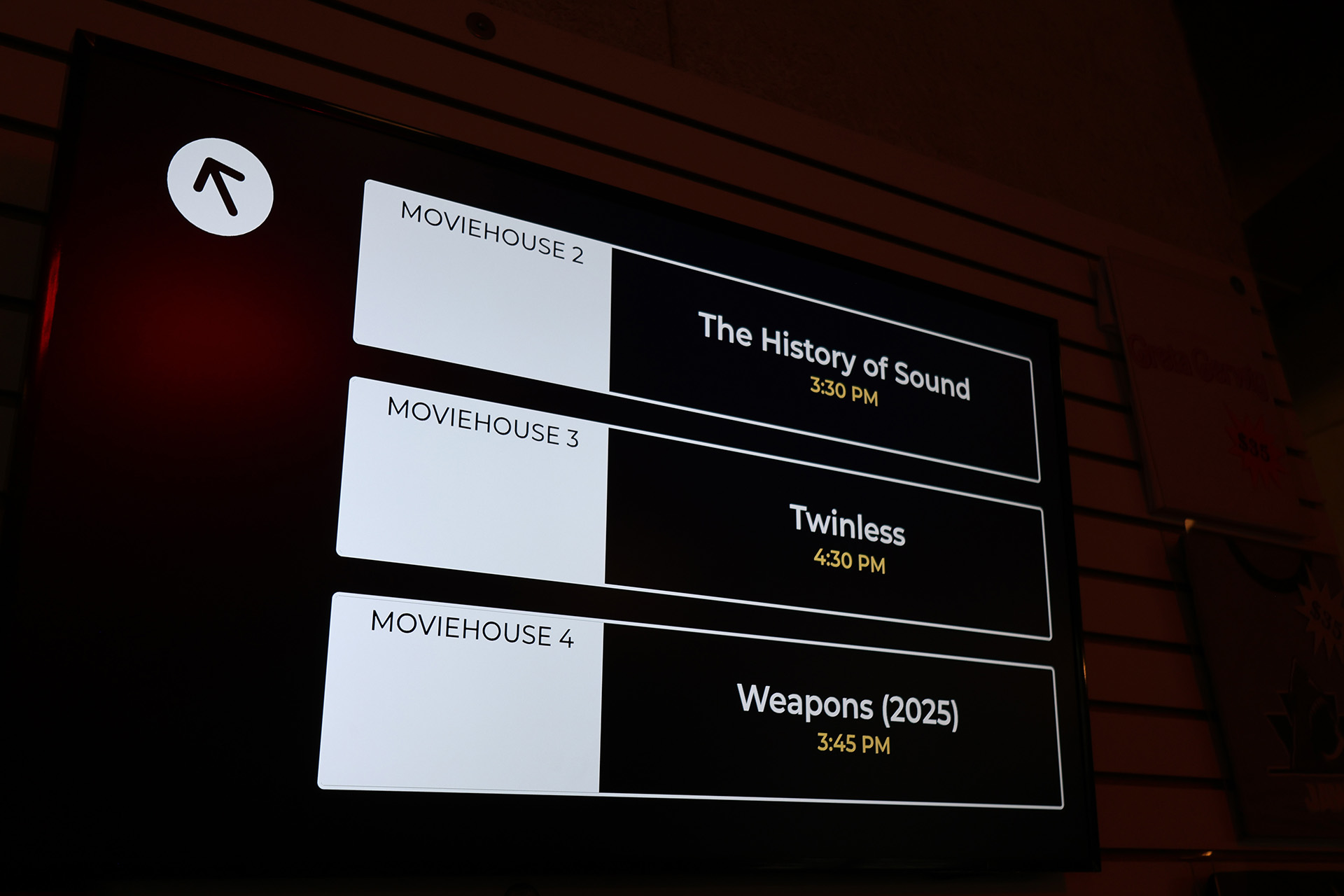 Photo of a screen that says what is playing in each of the Coolidge's screening rooms: The History of Sound, Twinless, and Weapons