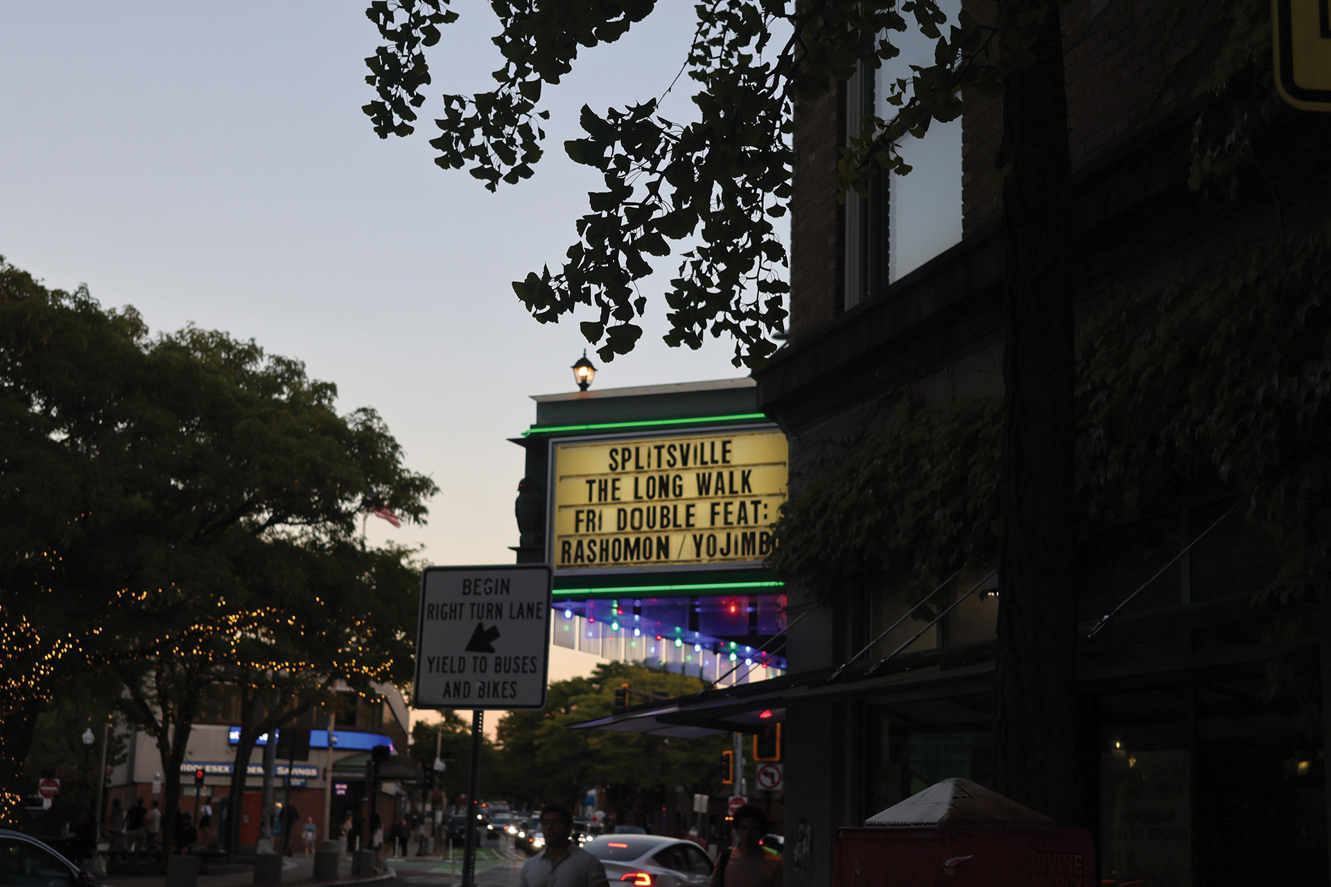 Photo showing a side view of the illuminated Somerville Theater sign that showcases upcoming films