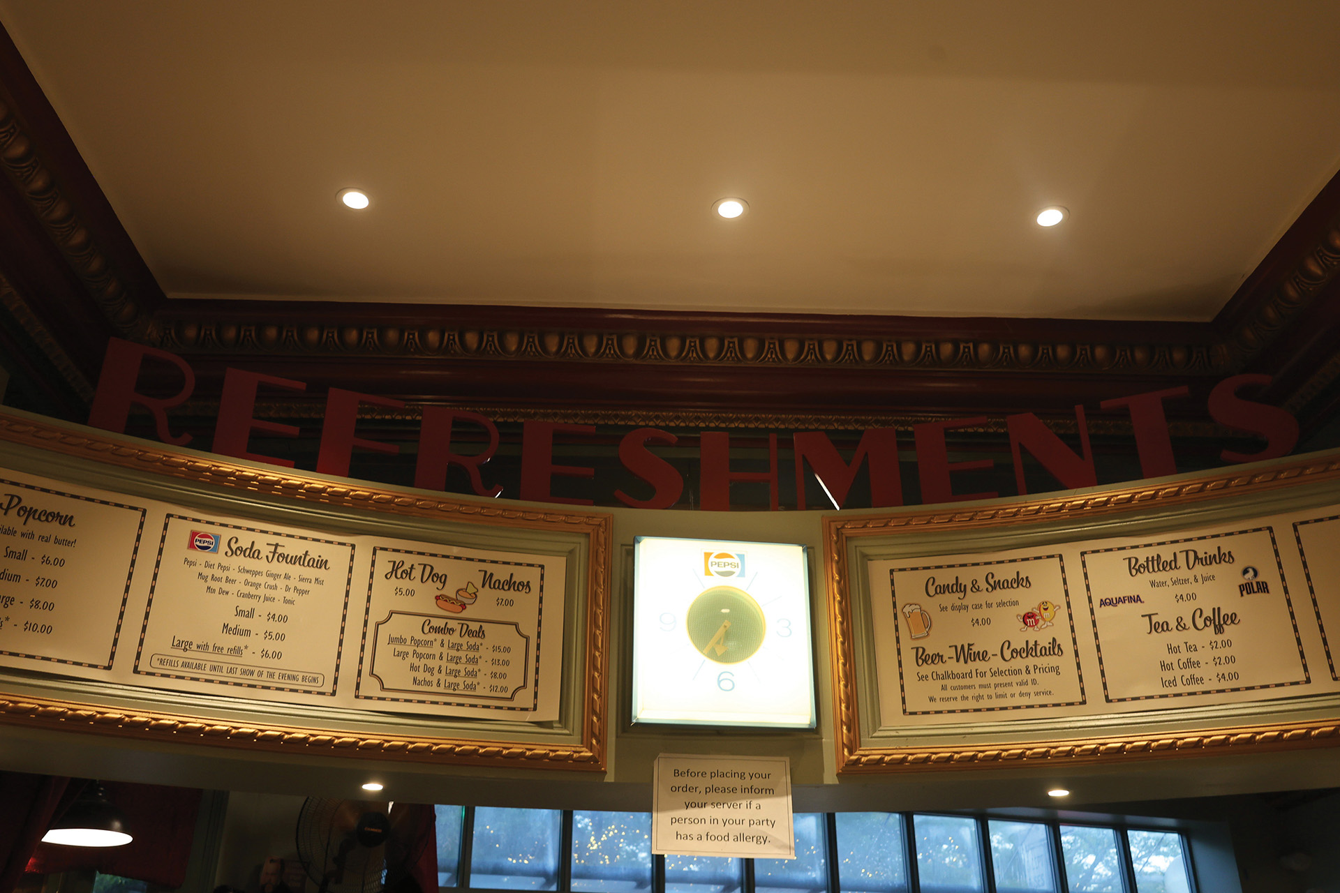 Photo of the concession stand with menu boards displaying snacks and beverages at the Somerville Theater