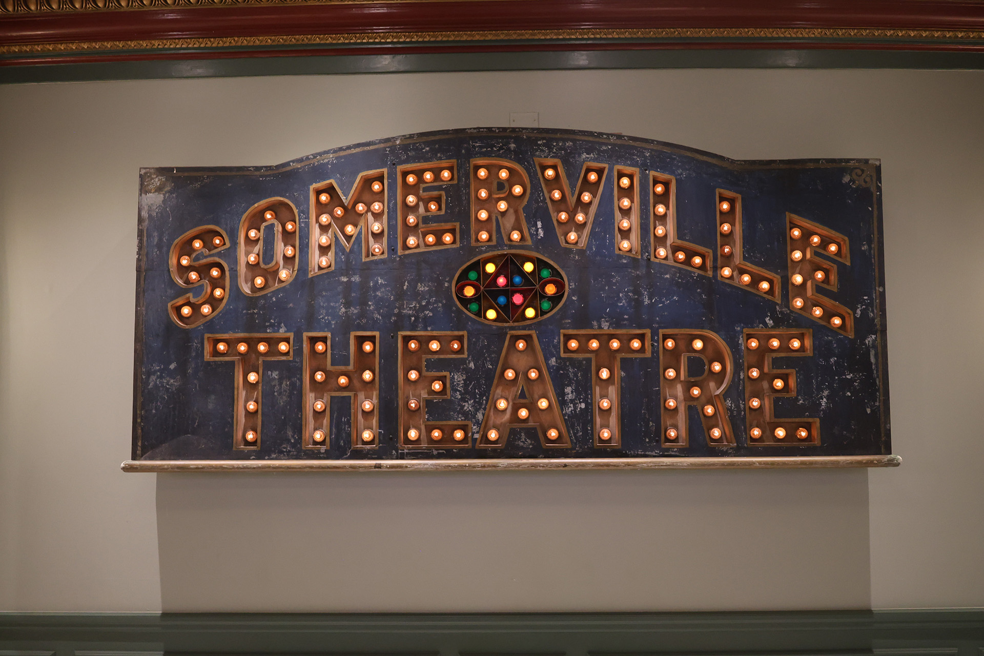 Close-up photo of a sign that says Somerville Theater