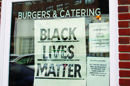 A Black Lives Matter sign posted in the window of a cafe