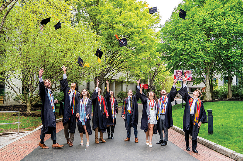 Northeastern University students throwing their graduation caps