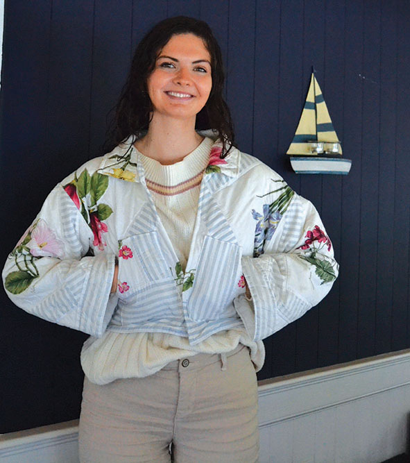 Maeve Stover smiling and wearing a jacket she made from thirfted materials