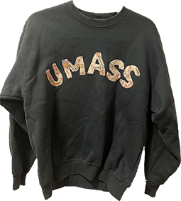 gray sweatshirt with letters U M A S S made out of a repurposed quilt placed in the center of the sweatshirt